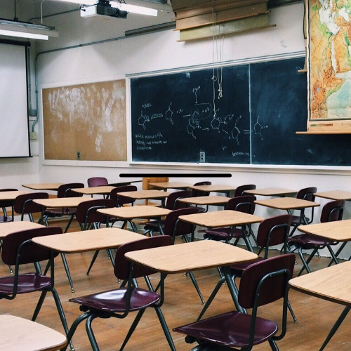 An empty classroom filled with old desks